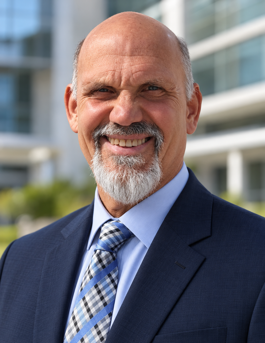 Dr. Russ L'HommeDieu, founder of Practical Innovations, in a navy suit outside a modern medical building